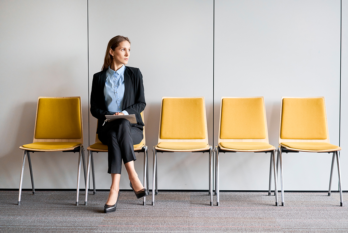 Professional woman between jobs waits to be interviewed for new position