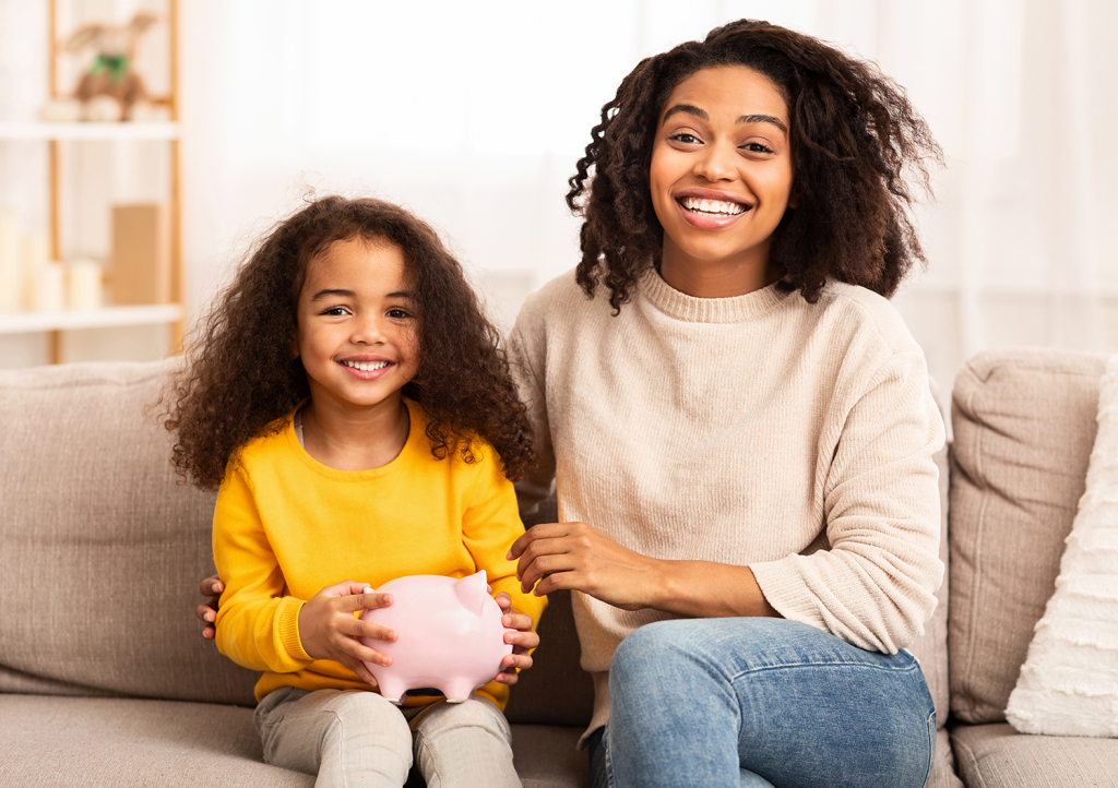 Mother and daughter holding a piggy bank