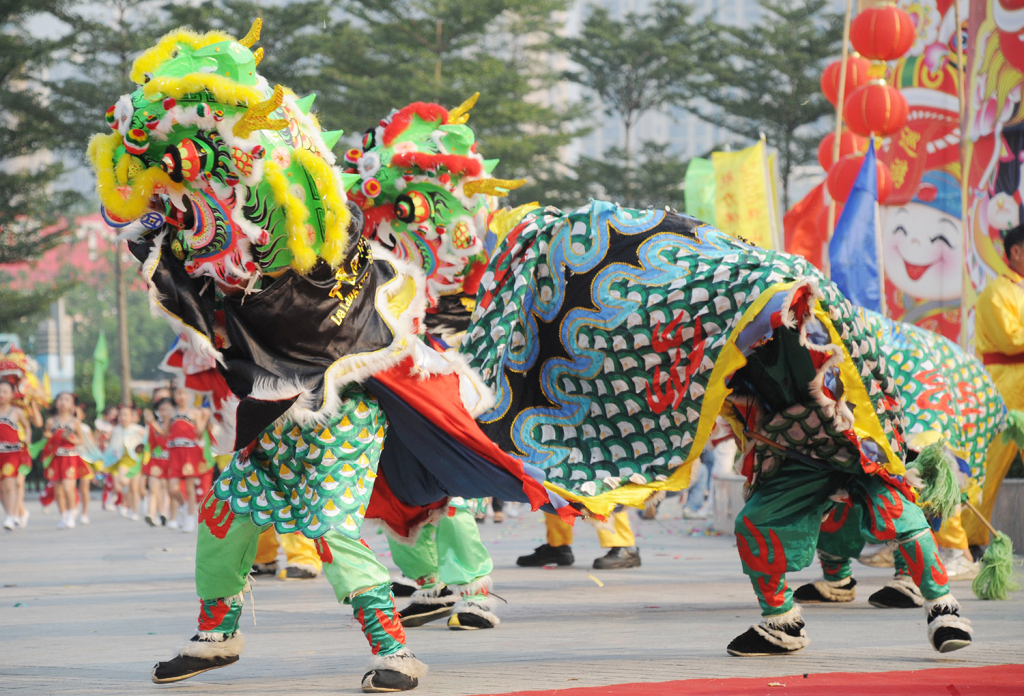 Chinese cultural dance with two men wearing a joint dragon costume