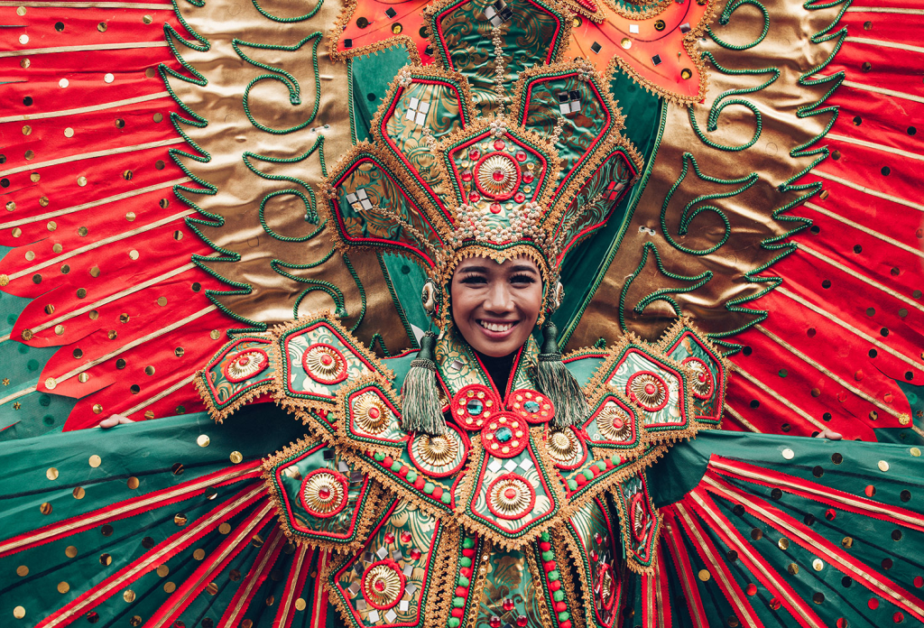 A smiling young woman wearing a traditional filipino costume