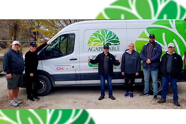 Volunteers in a front of an Agape Table food delivery truck