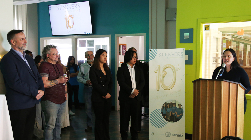 A student speaks at a podium during Stinger's Credit Union's 10th Anniversary