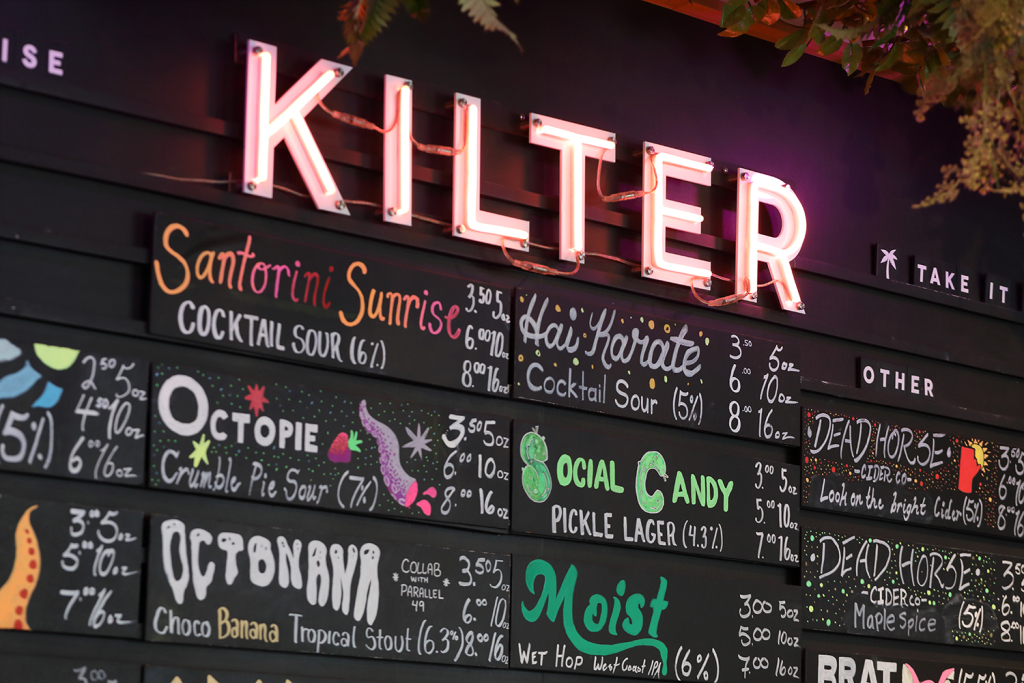 A look at Kilter Brewing Co's menu, written on a large chalk board.