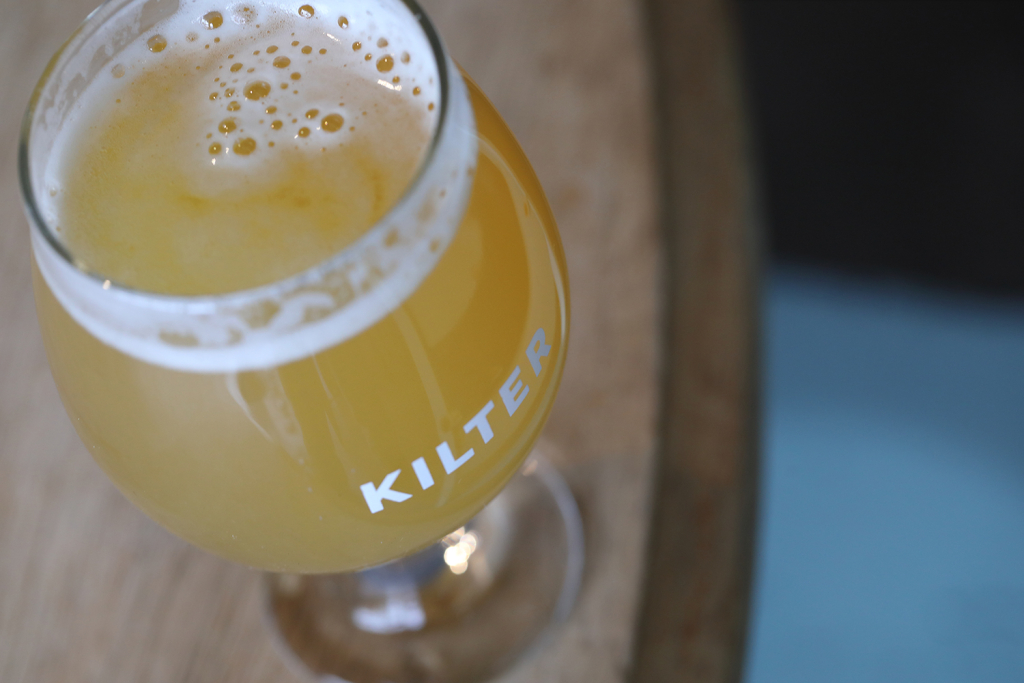 Overhead shot of a glass of Kilter Brewing Co beer.